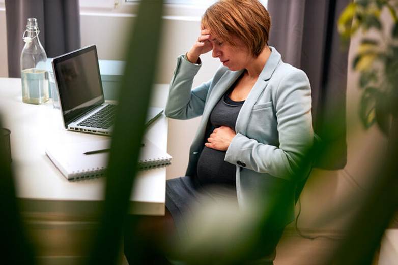 Pregnant woman stressed at work - Pregnancy Discrimination